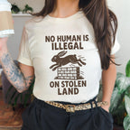 No Human Is Illegal T‑ graphic shirt featuring Social Justice Immigration Message in Daisy
