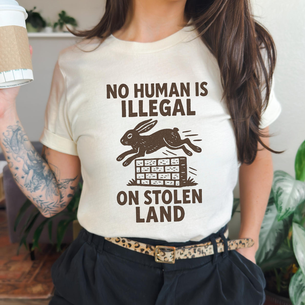 No Human Is Illegal T‑ graphic shirt featuring Social Justice Immigration Message in Daisy