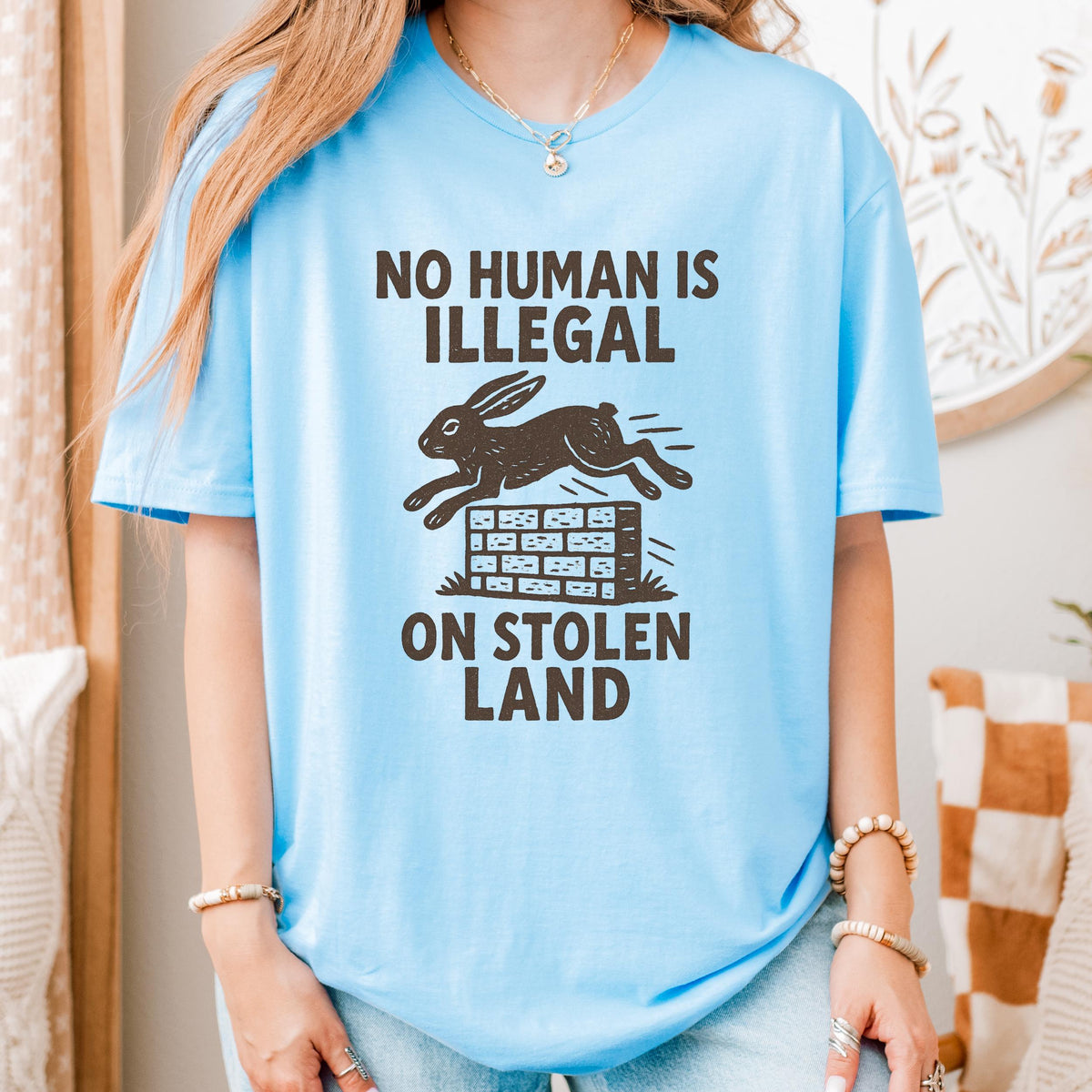 No Human Is Illegal T‑ graphic shirt featuring Social Justice Immigration Message