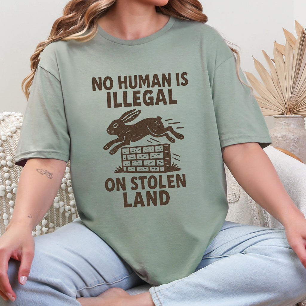 No Human Is Illegal T‑ graphic shirt featuring Social Justice Immigration Message