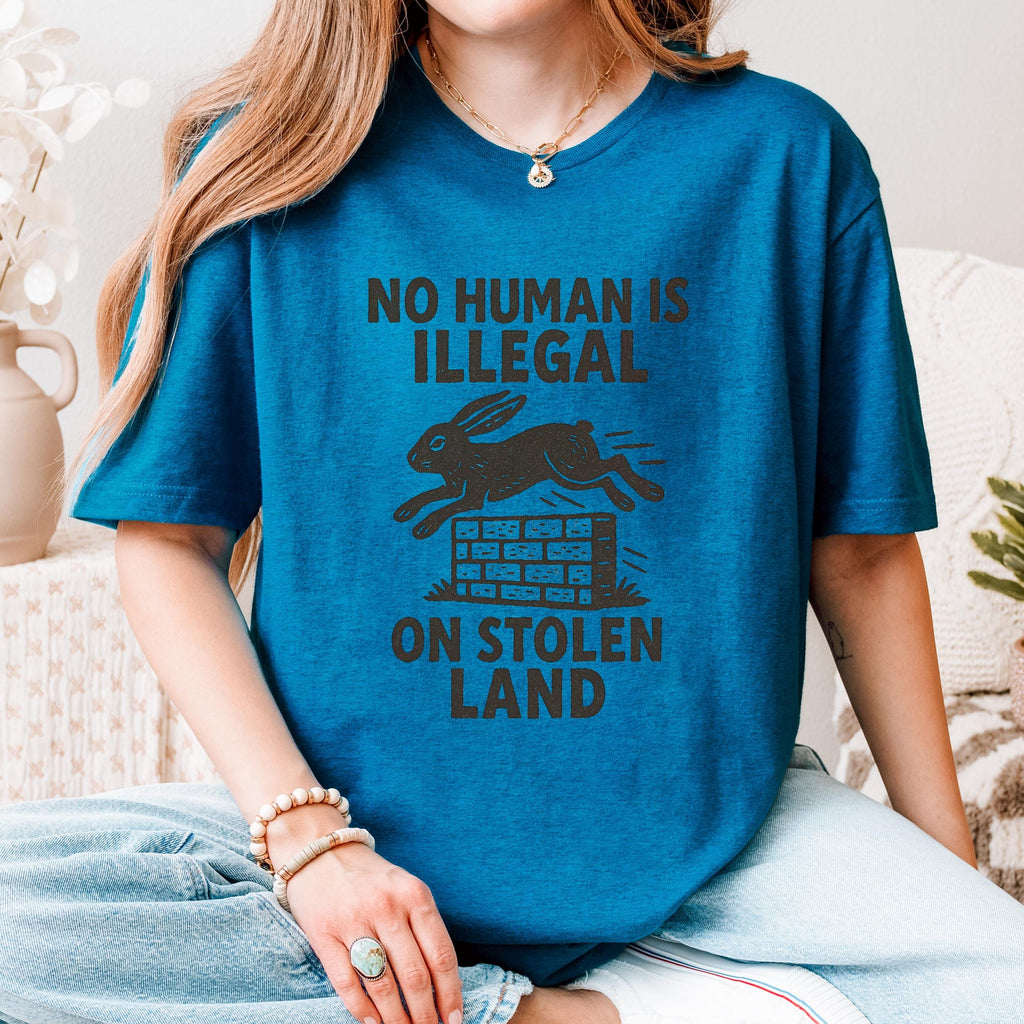 No Human Is Illegal T‑ graphic shirt featuring Social Justice Immigration Message