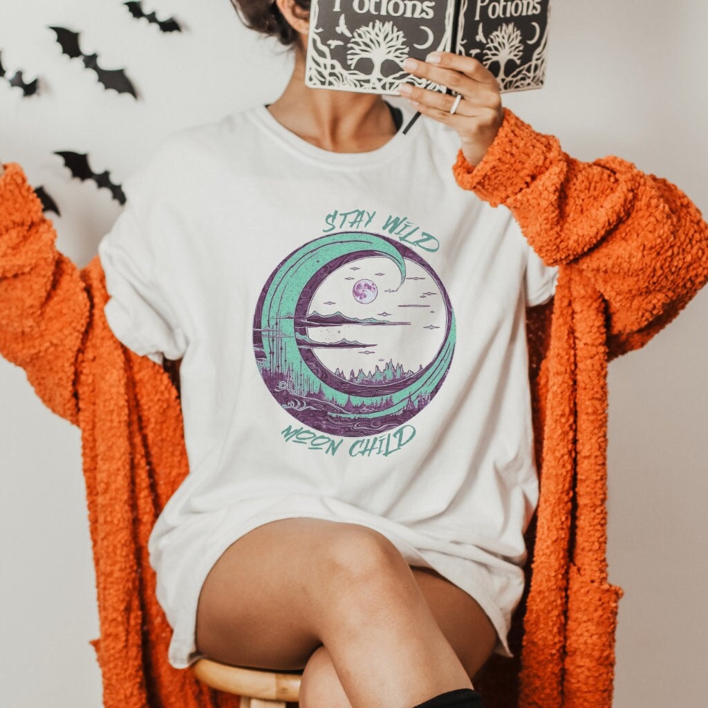 Stay Wild Moon Child graphic shirt featuring Crescent Moon Nature Graphic Tee in Baby Blue