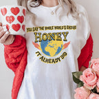Graphic graphic shirt featuring "You Say the Whole World’s Ending Honey It in Black