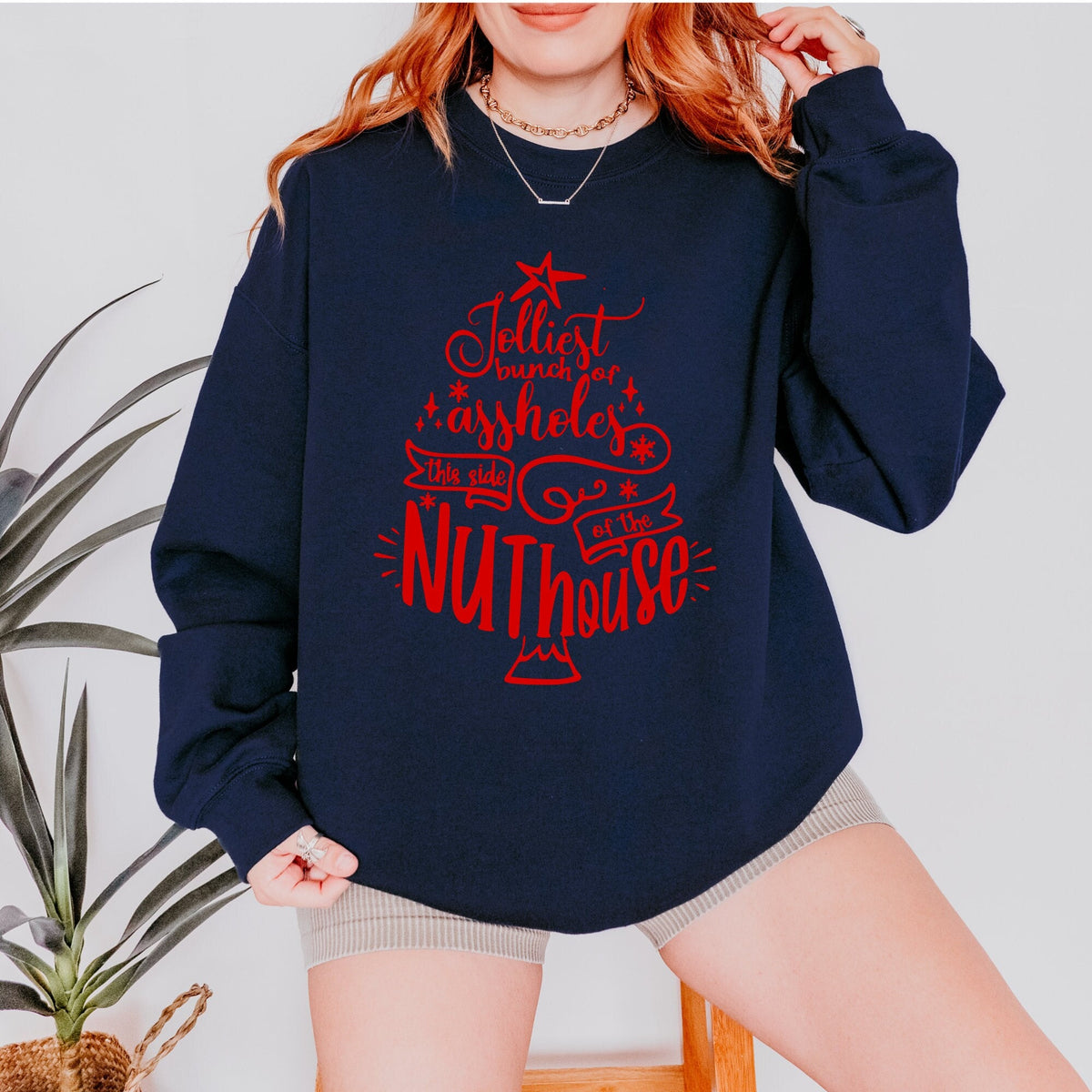 Christmas graphic sweatshirt featuring "Jolliest Bunch of A**holes in the Nuthouse"