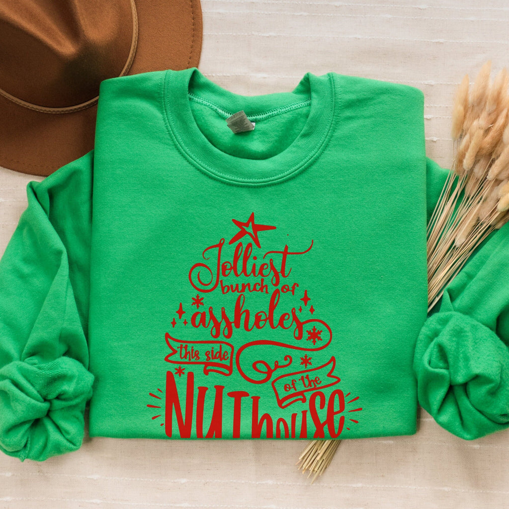 Christmas graphic sweatshirt featuring "Jolliest Bunch of A**holes in the Nuthouse"