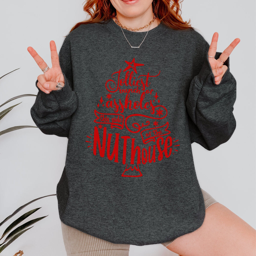 Christmas graphic sweatshirt featuring "Jolliest Bunch of A**holes in the Nuthouse"
