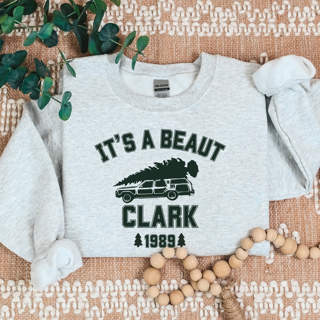 Crewneck Sweatshirt graphic sweatshirt featuring "It's a Beaut Clark 1989" Vintage Tree-Laden