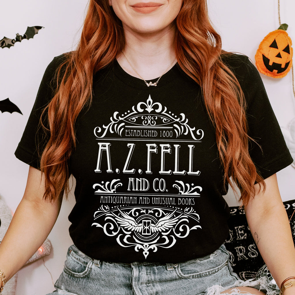 Good Omens A.Z. Fell and Co Antiquarian and Unusual graphic shirt featuring Aziraphale & Crowley Bookish Tee