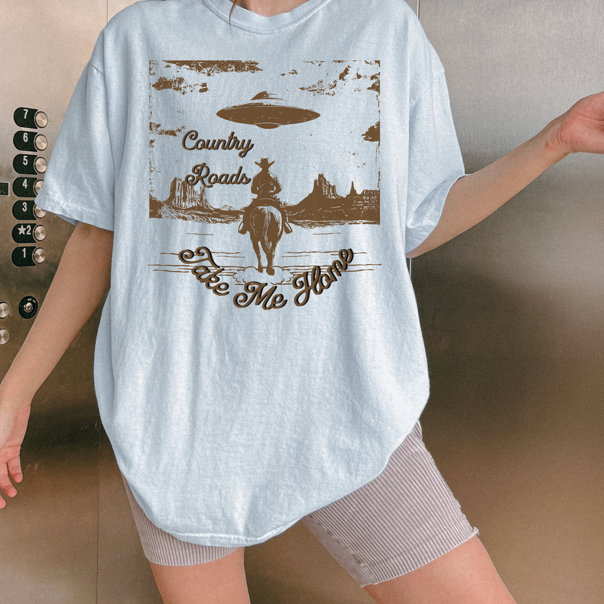 Country Roads Take Me Home graphic shirt featuring Cowboy UFO Western Graphic Tee