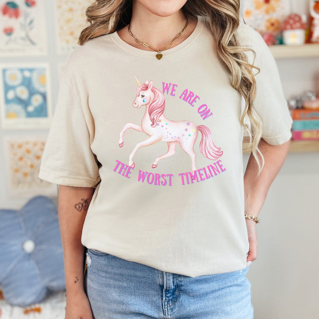 We Are on the Worst Timeline graphic shirt featuring Sad Unicorn Funny Graphic Tee