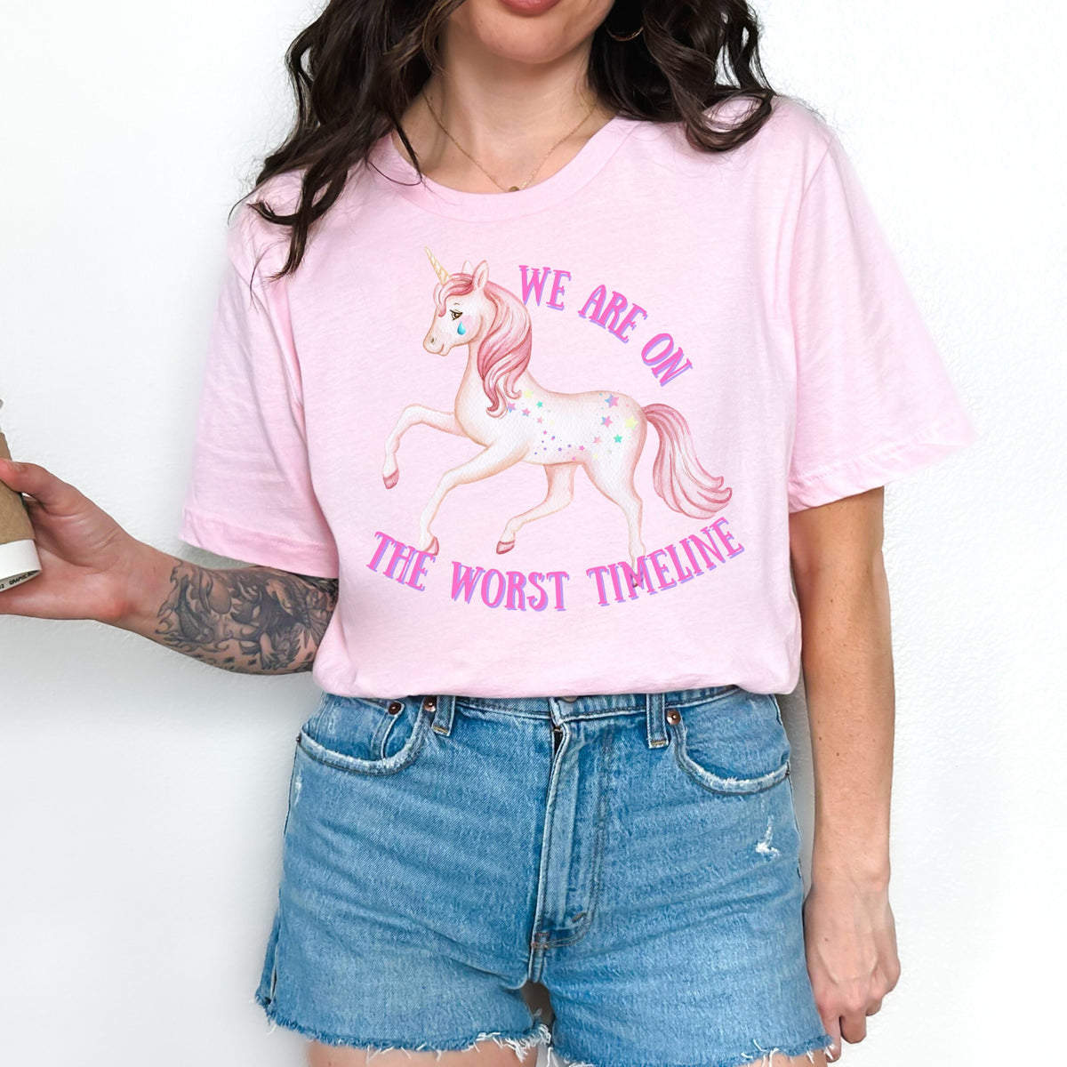 We Are on the Worst Timeline graphic shirt featuring Sad Unicorn Funny Graphic Tee