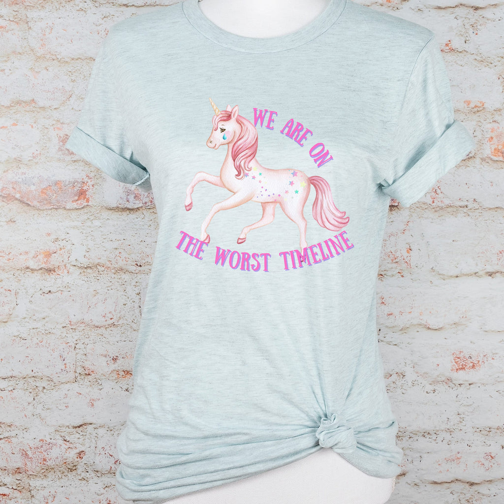 We Are on the Worst Timeline graphic shirt featuring Sad Unicorn Funny Graphic Tee