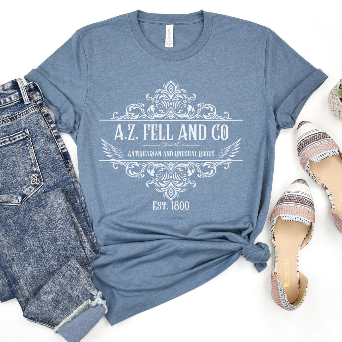 A.Z. Fell and Co graphic shirt featuring Good Omens Aziraphale Bookshop Graphic Tee