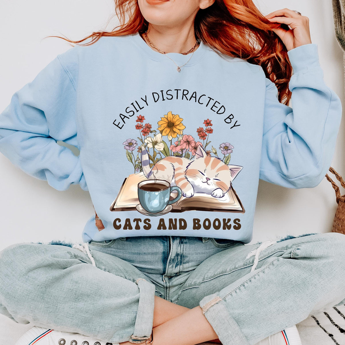 Easily Distracted by Cats and Books graphic sweatshirt featuring Book Lover Cat Crewneck