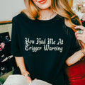 You Had Me at Trigger Warning graphic shirt featuring Funny Book Lover Graphic Tee in Black