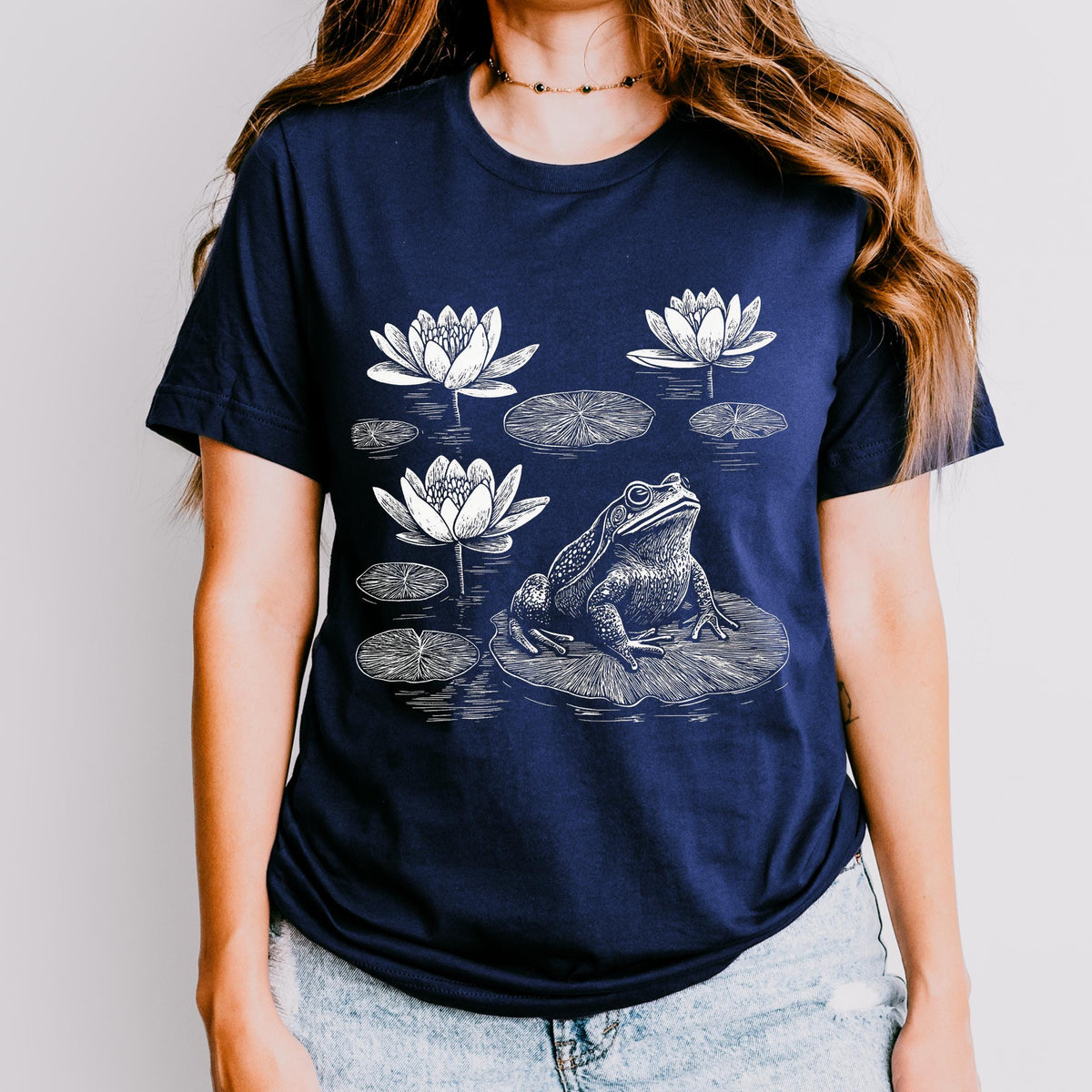 Frog graphic shirt featuring Linocut Frog & Water Lily Graphic Tee