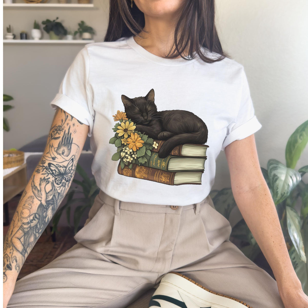 Black Cat Book Lover graphic shirt featuring Floral Book Stack Graphic Tee
