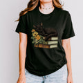 Black Cat Book Lover graphic shirt featuring Floral Book Stack Graphic Tee