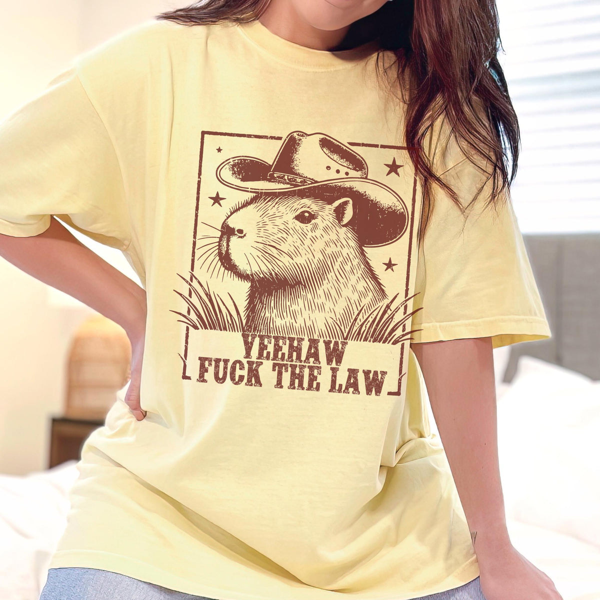 Yeehaw Fuck the Law Capybara graphic shirt featuring Funny Western Animal Graphic Tee