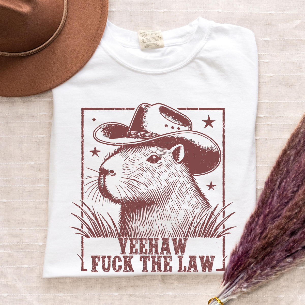 Yeehaw Fuck the Law Capybara graphic shirt featuring Funny Western Animal Graphic Tee