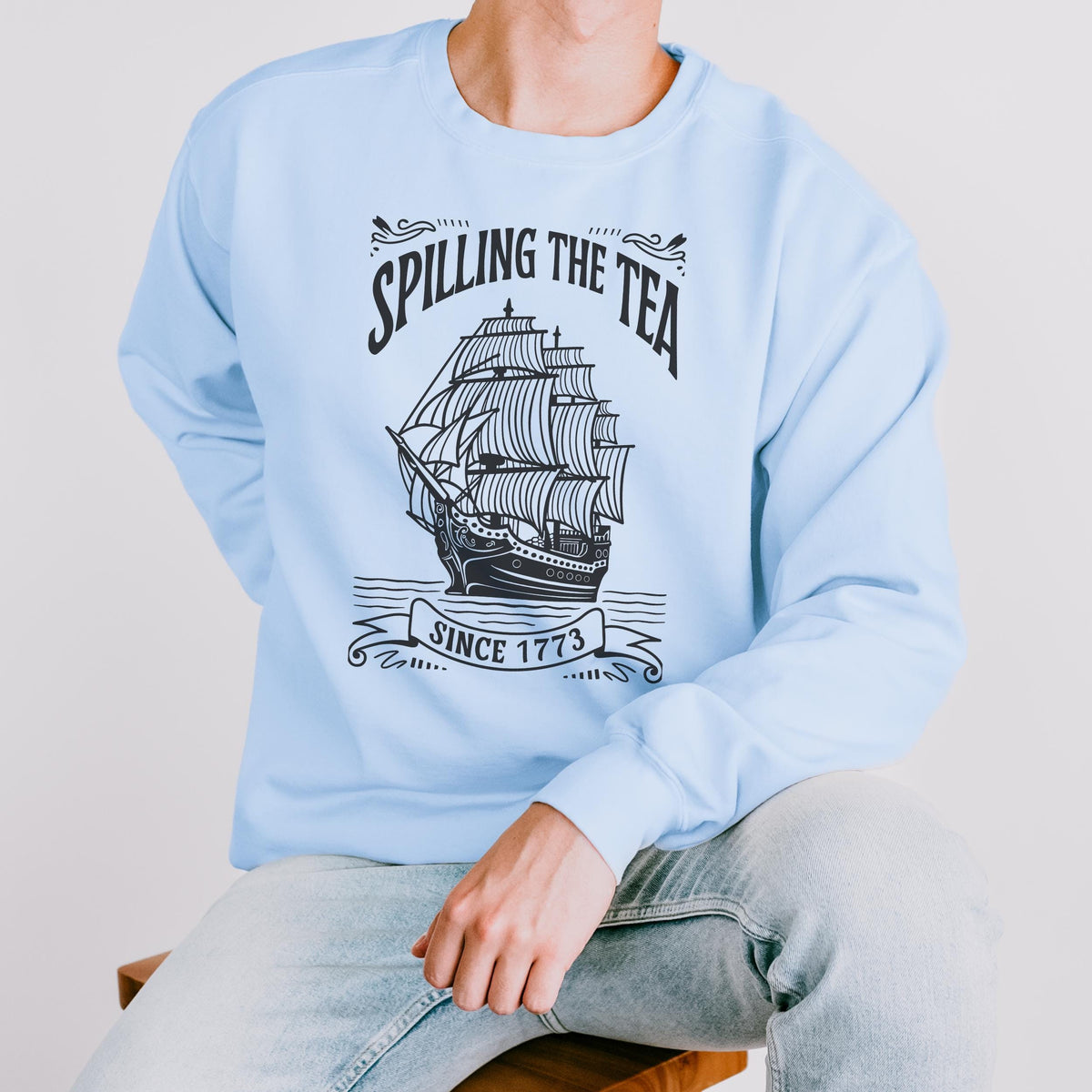 Spilling the Tea Since 1773 graphic sweatshirt featuring Boston Tea Party