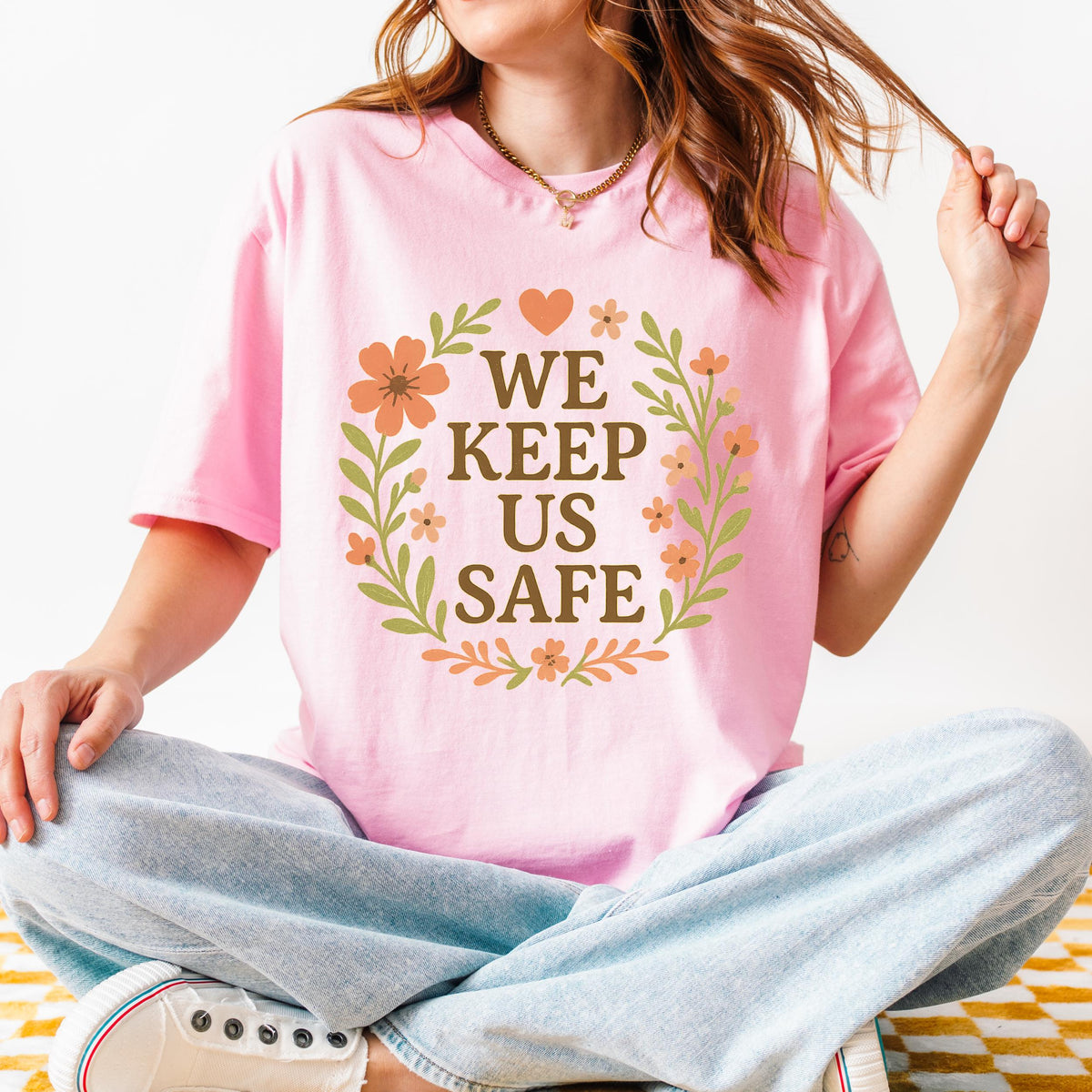 We Keep Us Safe graphic shirt featuring Mutual Aid & Community Care Floral