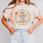 We Keep Us Safe graphic shirt featuring Mutual Aid & Community Care Floral in White