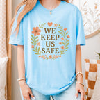 We Keep Us Safe graphic shirt featuring Mutual Aid & Community Care Floral
