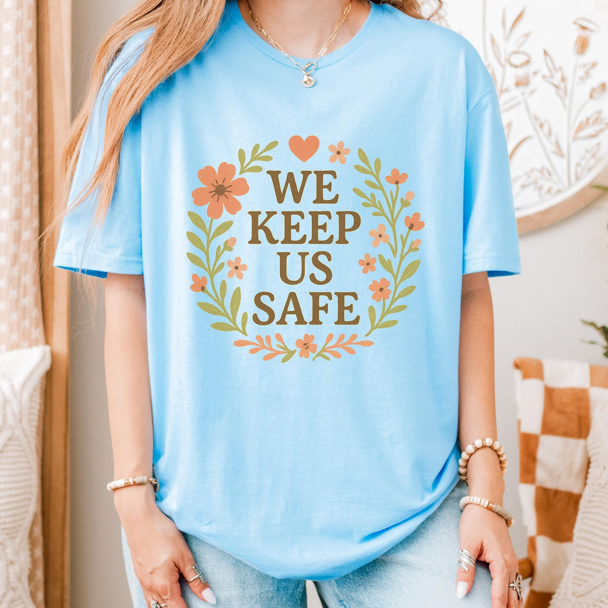 We Keep Us Safe graphic shirt featuring Mutual Aid & Community Care Floral
