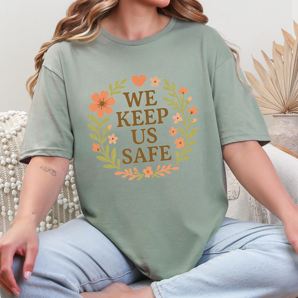 We Keep Us Safe graphic shirt featuring Mutual Aid & Community Care Floral