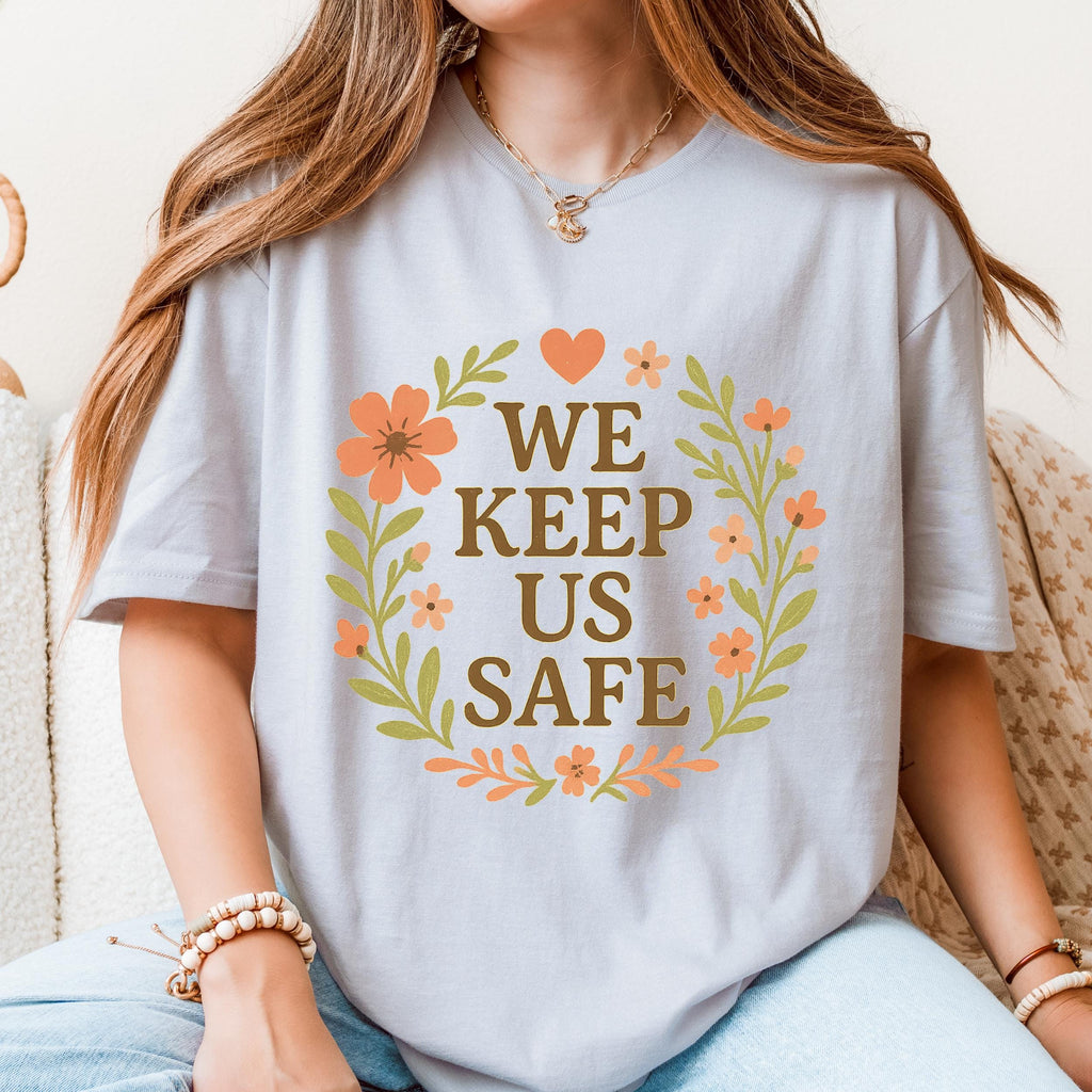 We Keep Us Safe graphic shirt featuring Mutual Aid & Community Care Floral