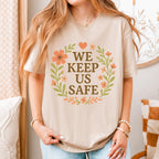 We Keep Us Safe graphic shirt featuring Mutual Aid & Community Care Floral