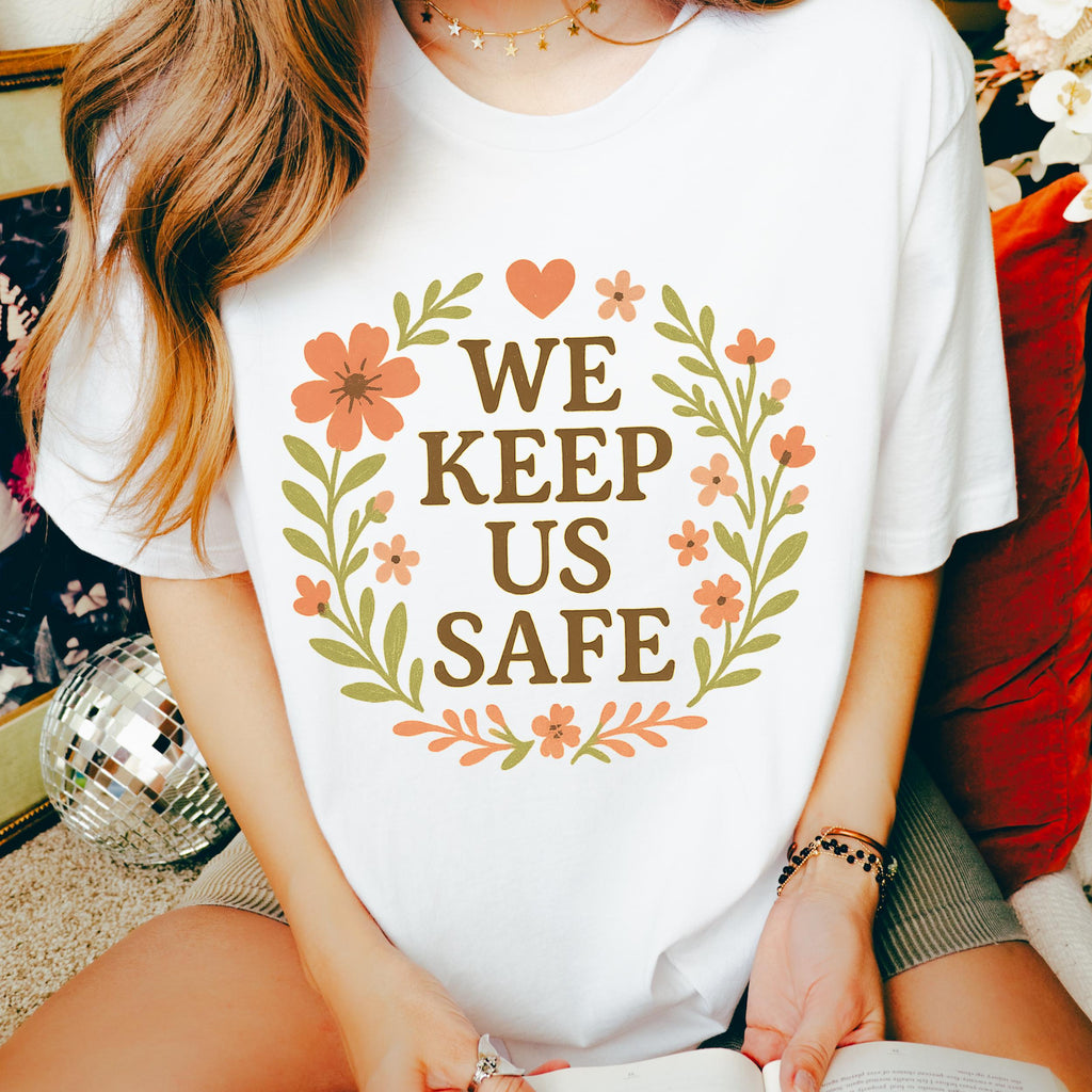 We Keep Us Safe graphic shirt featuring Mutual Aid & Community Care Floral