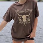 Product photo of Raisin’ Hell — Western Cow Skull Floral Design T-shirt