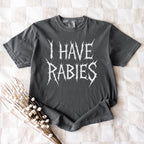 The Faithful Familiar charcoal Comfort Colors graphic tee with white distressed metal-style text reading I HAVE RABIES.
