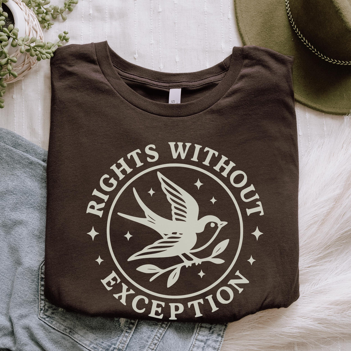 The Faithful Familiar dark green unisex graphic tee with a cream swallow bird emblem and Rights Without Exception text.