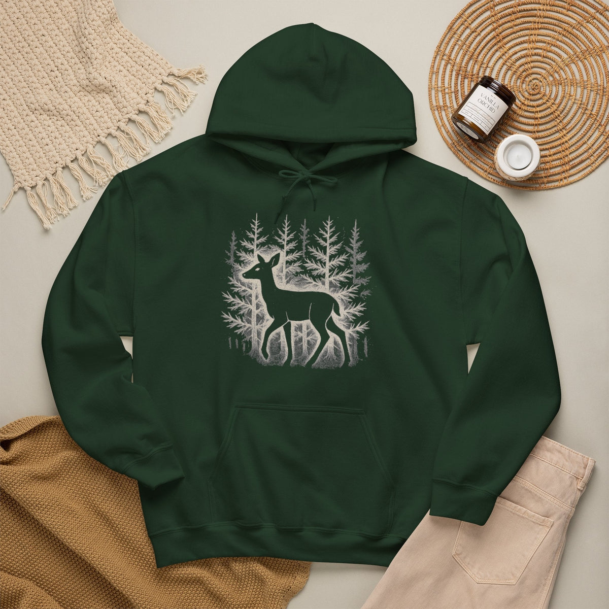 The Faithful Familiar forest green pullover hoodie featuring a white deer and pine tree graphic on the front.