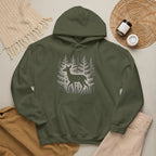 The Faithful Familiar forest green pullover hoodie featuring a white deer silhouette graphic in a snowy pine forest.