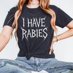 The Faithful Familiar black Comfort Colors graphic t-shirt with white spiky metal-style text reading I HAVE RABIES.