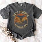 The Faithful Familiar charcoal grey Comfort Colors t-shirt with a vintage Mothman badge graphic in mustard and rust.
