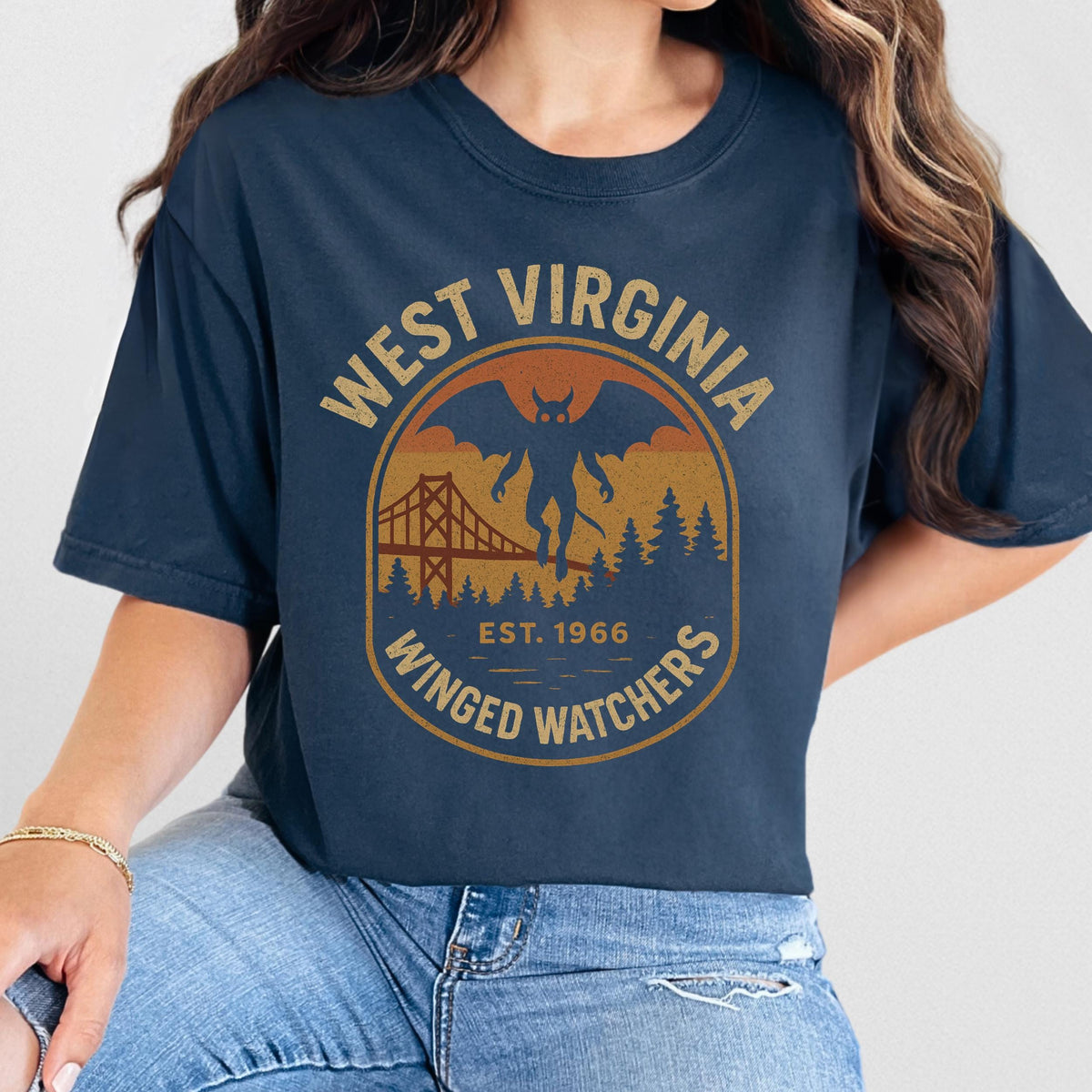 The Faithful Familiar navy Comfort Colors t-shirt with a vintage Mothman graphic in mustard, rust, and muted orange.