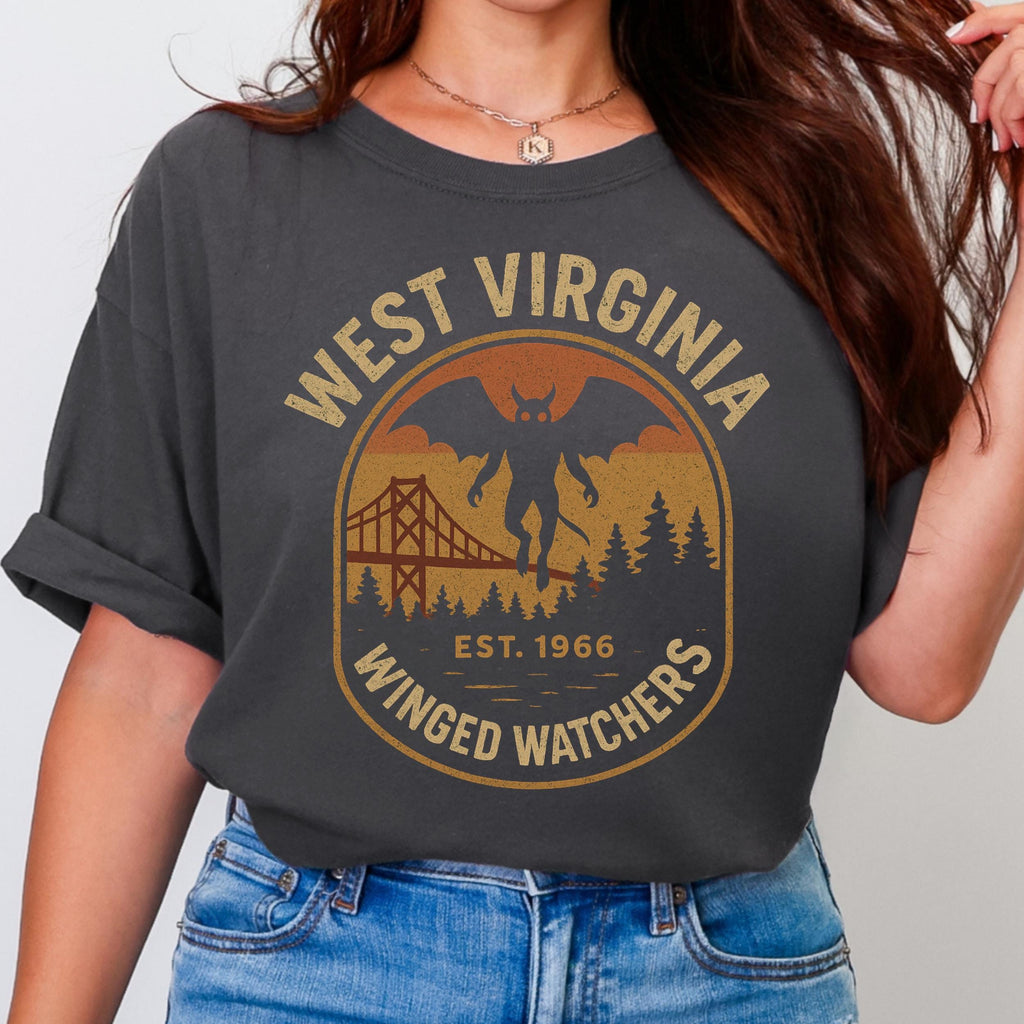 The Faithful Familiar charcoal Comfort Colors t-shirt with a vintage Mothman graphic in mustard and rust tones.