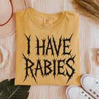 The Faithful Familiar mustard yellow Comfort Colors graphic tee with black metal-style I HAVE RABIES text.