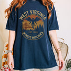 The Faithful Familiar navy blue Comfort Colors t-shirt with a vintage Mothman graphic and West Virginia badge design.
