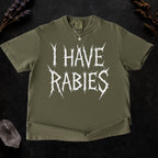 The Faithful Familiar olive green Comfort Colors graphic tee with white spiky metal-style text reading I HAVE RABIES.