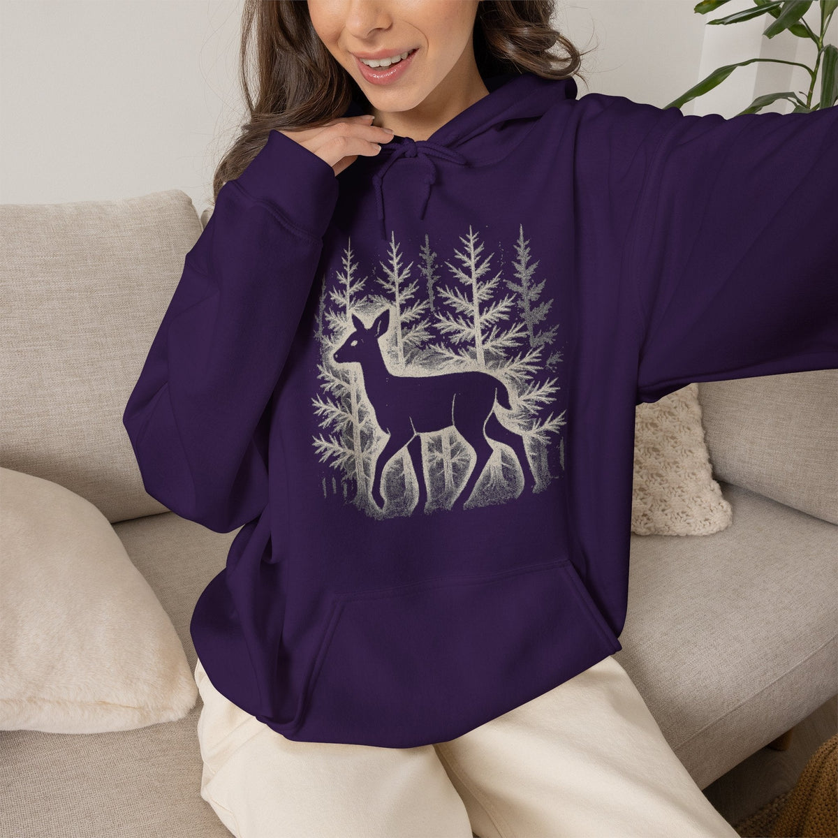 The Faithful Familiar dark purple pullover hoodie featuring a white deer silhouette graphic in a snowy forest scene.