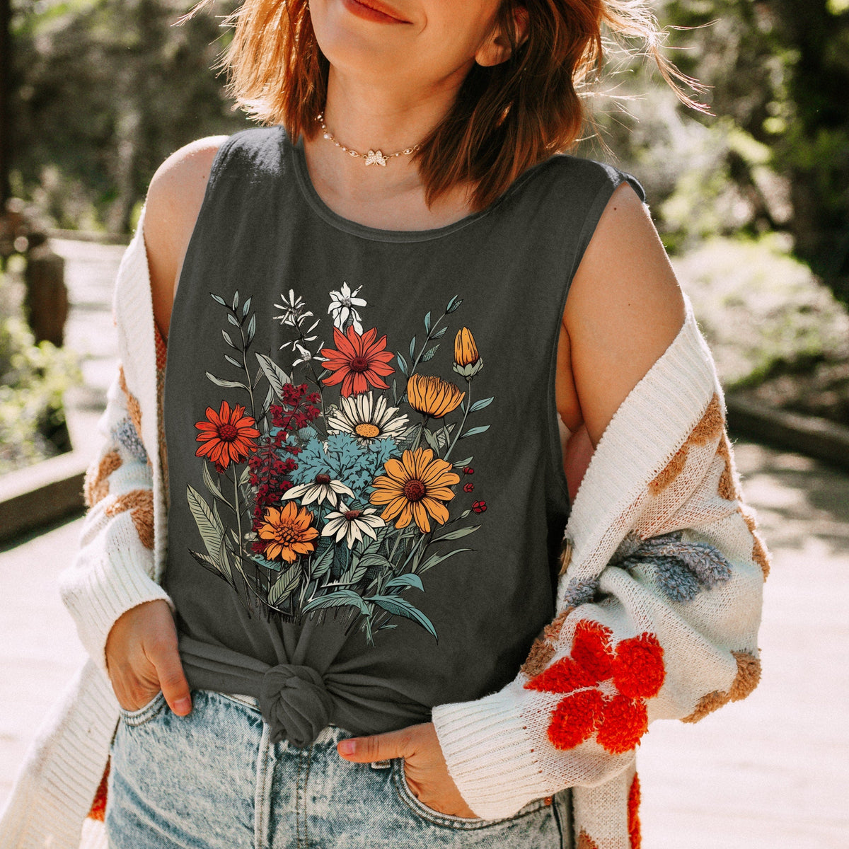 The Faithful Familiar charcoal grey cotton tank top with a vintage wildflower graphic, worn with a knit cardigan.